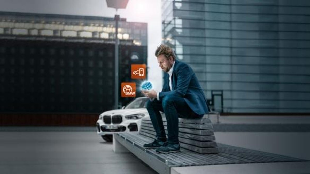 BMW connected drive man sitting on bench 
